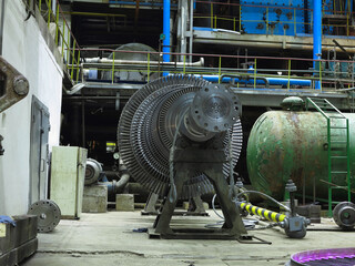 Power generator steam turbine in repair process, machinery, pipes, tubes at power plant
