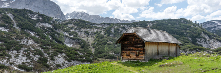 Fototapeta na wymiar Wooden hut in the austrian alps. Panoramic image. Austria