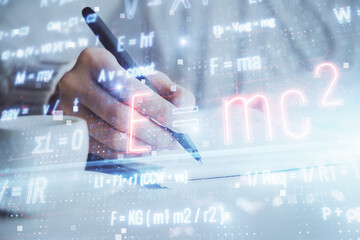 Science formula hologram over woman's hands taking notes background. Concept of study. Double...