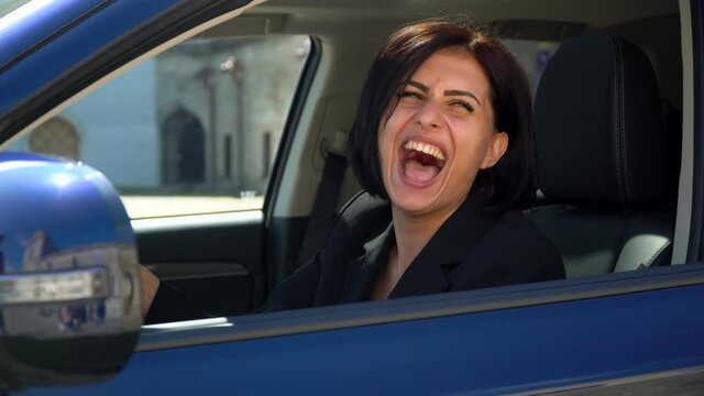 Funny beautiful businesswoman laugh in car salon