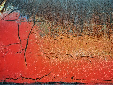 The rust that is attached to the metal tank is broken into beautiful traces.