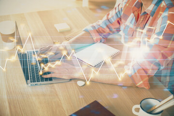 Multi exposure of forex graph with man working on computer on background. Concept of market analysis.