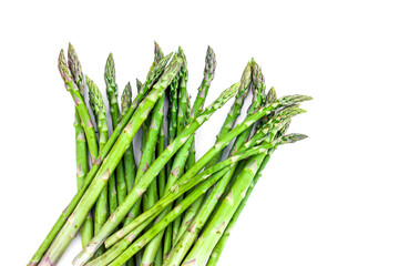 Bunch of fresh Asparagus on white background. Green raw sprouts of Asparagus Officinalis. Spring vegetables for healthy eating and lifestyle. Top View. Space for text.