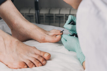 Young woman getting professional pedicure in beauty salon