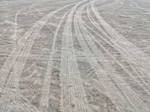 Abstract texture of wheel marks on soil roads. Tire marks of car.