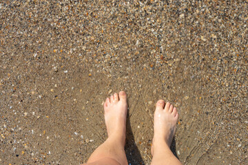 Legs in water.  women's feet in the clear water. summer concept