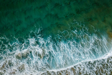 An aerial view of waves crashing on a beach , New South Wales in the morning