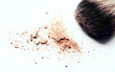 Makeup brush and loose powder on a white background. Cosmetic product for makeup artist. Close-up.