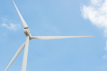 Close-up wind turbine in rotation to generate electricity energy on outdoor with  blue sky background, Conservation and sustainable energy concept.
