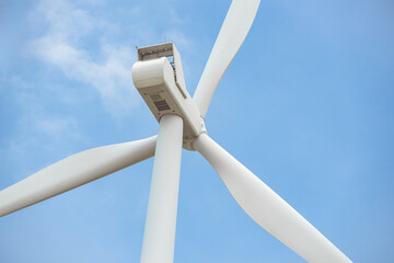Close-up wind turbine in rotation to generate electricity energy on outdoor with  blue sky...