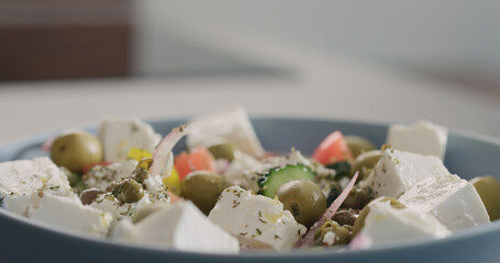 Closeup greek salad in blue bowl