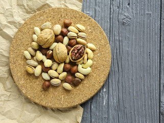 Nuts decorated in a plate on a wooden desk