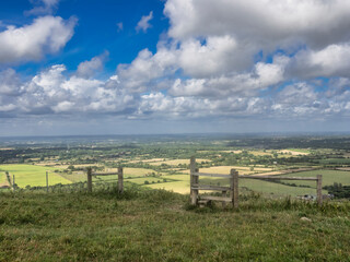 tunning vibrant landscape image of English countryside on lovely Summer afternoon overlooking rolling hills and country villages