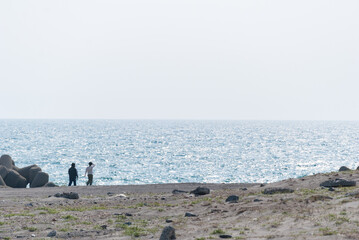 海とビーチをあるく人