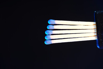 Lit matches and blown out in the studio photographed with colorful foils before the flashes