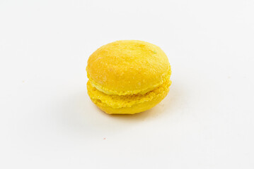 Yellow sweet macaroon on a white background