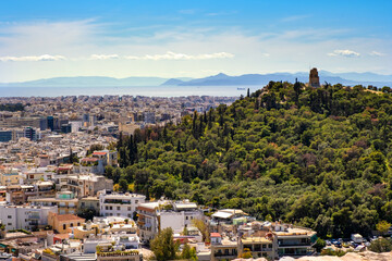 Fototapeta na wymiar Panoramic view of metropolitan Athens with Philopappos Monument and Philopappou Hill - Mouseion Hill - seen from Acropolis hill in Athens, Greece