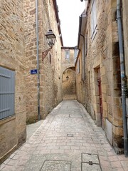 Fototapeta na wymiar Sarlat la Caneda, France - July 2, 2020: Picturesque street in the medieval old town of Sarlat la Caneda, Périgord, Dordogne, France