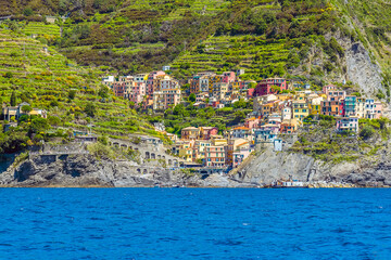 A view from the sea up the main street of the Cinque Terre village of Manarola, Italy in the summertime