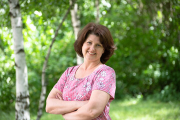 Woman in a pink dress in a summer park