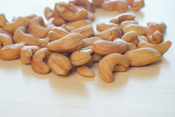 Roasted Cashew nuts  on the wood floor background,close up