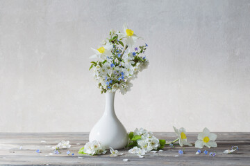 spring flowers in vase on wooden table