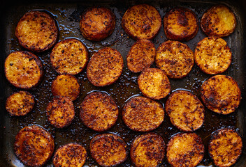 Baked potato with different spices top view