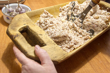 Chop aspic, aspic from meat with a hoe in an old wooden trough. Russian old village traditions for holidays.
