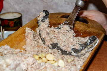 Chop aspic, aspic from meat with a hoe in an old wooden trough. Russian traditions for Christmas.
