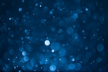 abstract sparkle bokeh light effect with navy blue background