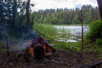 Campsite with fireplace in nature close to lake. Lithuania