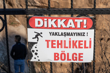 Siirt Deliklitas Botan Valley National Park with security barrier and warning sign in focus, shallow depth of field,  Southeastern Anatolia of Turkey, Warning sign writing "Caution dangerous area"
