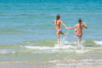 Children fun and funny run swimming in the sea, left empty place for insertion