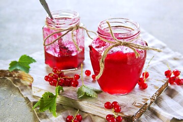 Homemade  red currant  jam in curly jar  on a light gray concrete background.  Jam recipes. Harvest berries.