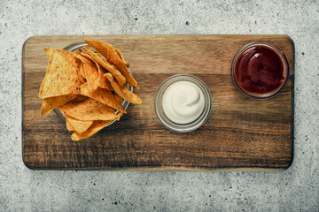 Corn cheese, snacks with sauce on a wooden stand. Beer snack, dish on the menu. Close up.