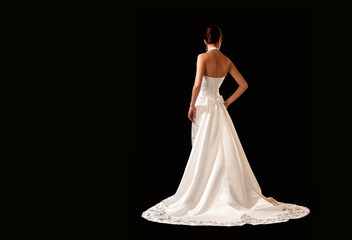 Fototapeta na wymiar bride in wedding dress on black background