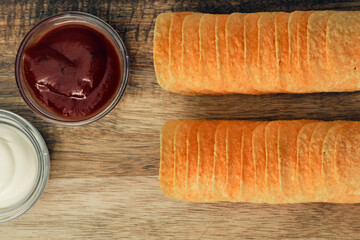 Potato chips on a wooden stand with sauces. Ready meal from the menu. Unhealthy food and beer snack.