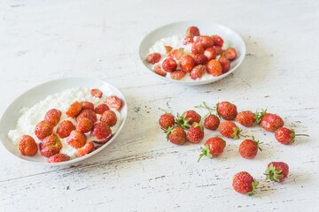 Healthy breakfast. Diet curd with fresh strawberries on a white vintage table.