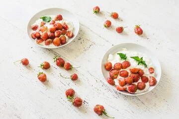 Healthy breakfast. Diet curd with fresh strawberries on a white vintage table.