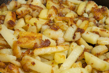 frying potatoes. chopped potato slices are fried in a pan in oil, close-up. cooking potatoes.