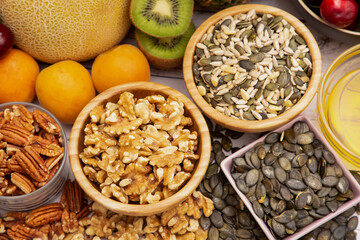 Group Nuts put on the bowl and fruit is banana, pineapple and grape is the food healthy on the wooden table background
