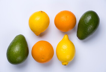Close up of citrus fruits orange, lemon, avocado and lime isolated on white background.