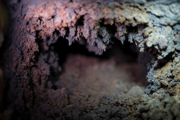 background texture of a mine well pipe furnace which is covered with a large layer of black soot