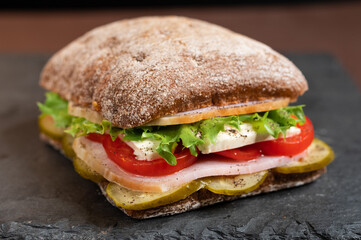 Photo of a sandwich in a tight. Macro photo of a sandwich.