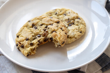 fresh baked classic chocolate chip cookies with nuts on a plate