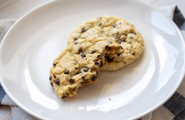 fresh baked classic chocolate chip cookies with nuts on a plate