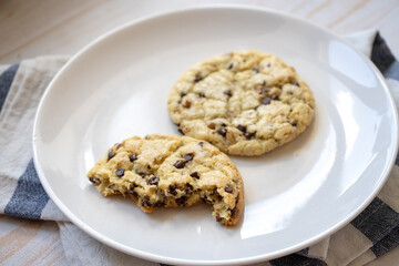 fresh baked classic chocolate chip cookies with nuts on a plate