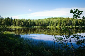 Fototapeta na wymiar Beautiful and prestine lakes and forests are a part of the nature of Dalarna in Sweden.