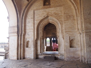 Fototapeta na wymiar Beautiful building and a woman, Ibrahim Rauz, Bijapur, Karnataka, South India, India