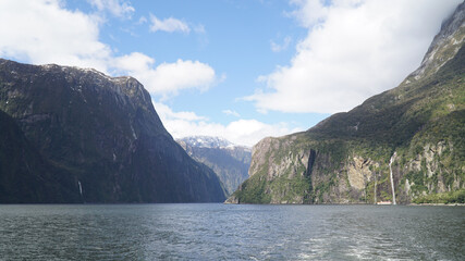 Steep mountain cliffs in Milford Sound Fiordland National Park, New Zealand.